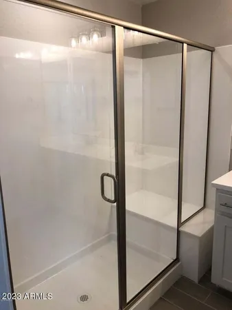 a bathroom with a glass shower door