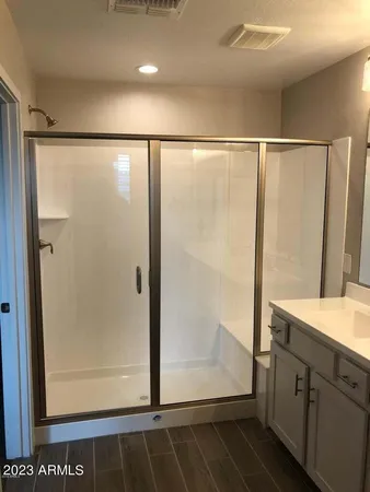 a bathroom with a shower and a mirror