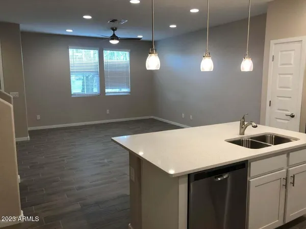 a kitchen with a sink and chandelier