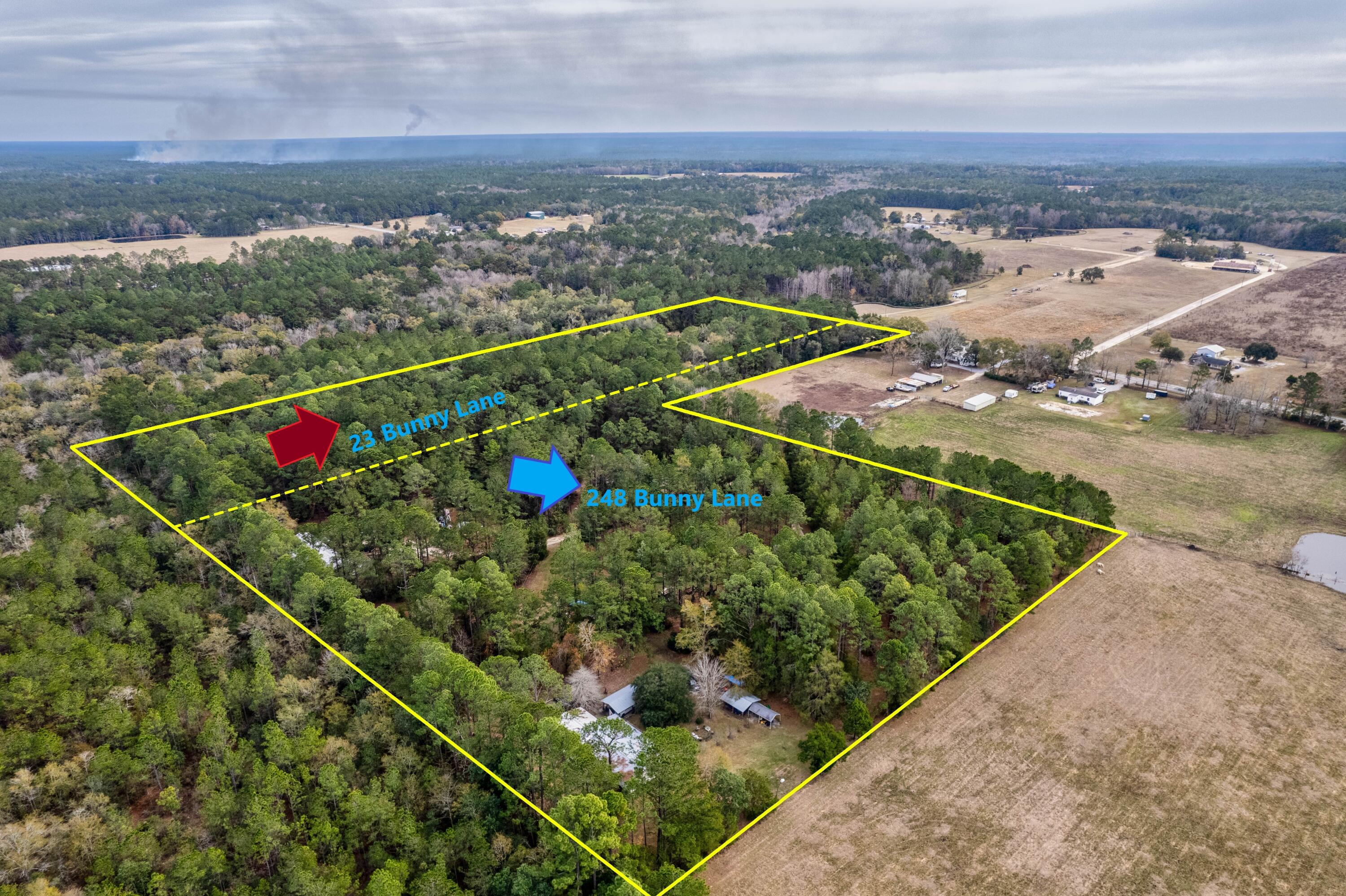 an aerial view of a residential houses with outdoor space and ocean view
