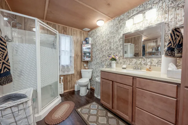 a bathroom with a sink toilet and shower
