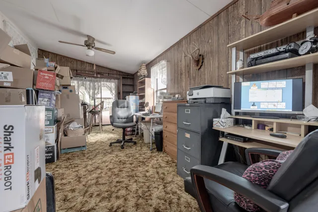 a view of a house with a yard and large trees