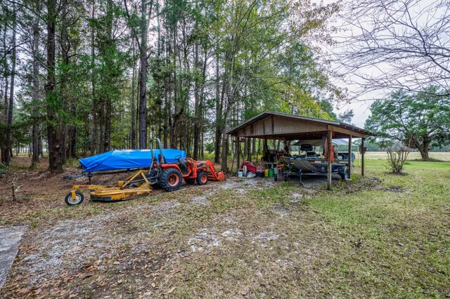 a backyard of a house with table and chairs