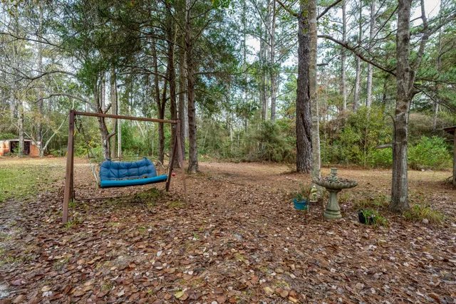 a view of a house with backyard and sitting area