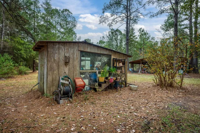 a house with lots of trees in the background