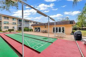 a view of a patio with table and chairs potted plants with wooden fence