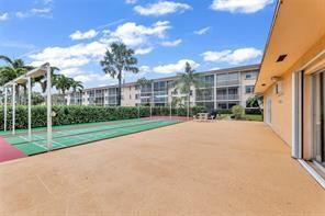 4500 North Federal Highway, Unit 153 Lighthouse Point, FL 33064 - Photo 5 of 7 a view of a house with a yard and potted plants