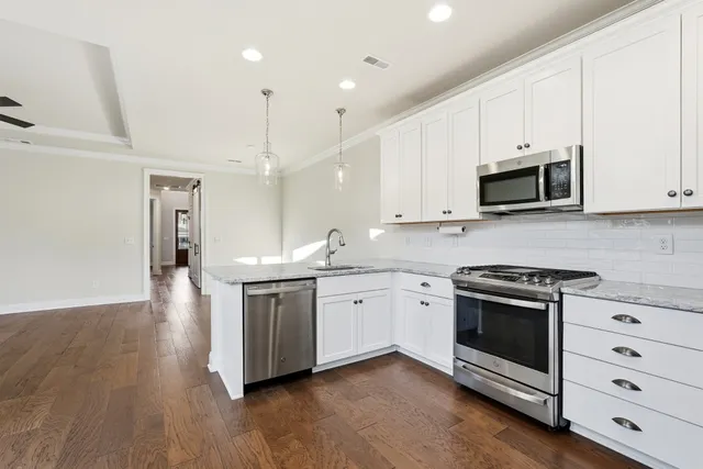 a view of a kitchen with a refrigerator and a sink