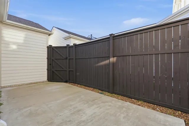 a patio with patio couch and potted plants