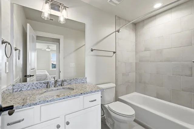 a bedroom with two beds and a lamp