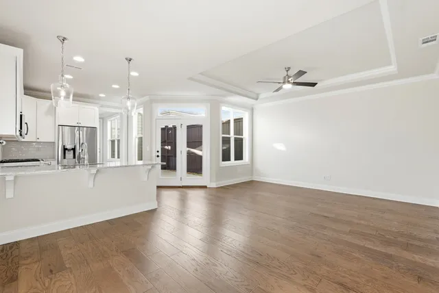 a view of a dining room with furniture and wooden floor