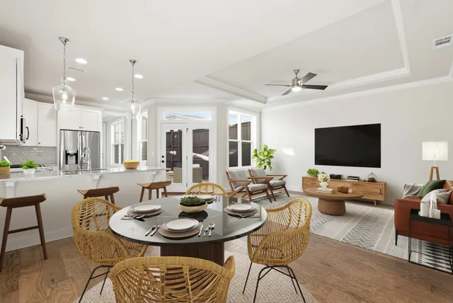 a kitchen with stainless steel appliances granite countertop a refrigerator a sink dishwasher a stove and white cabinets with wooden floor