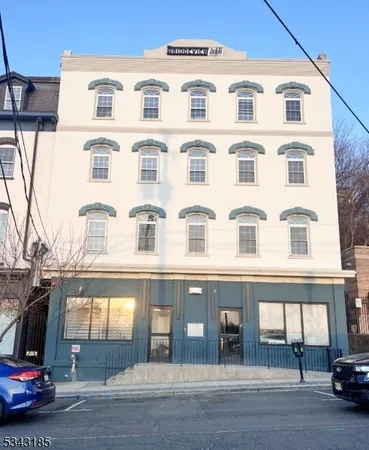 a view of a building with car parked