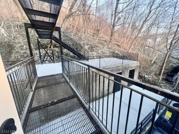 a view of balcony with wooden floor and fence