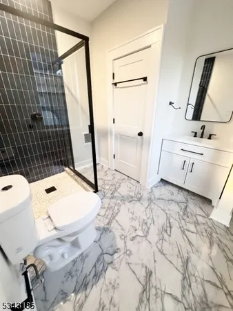a bathroom with a sink a toilet and mirror