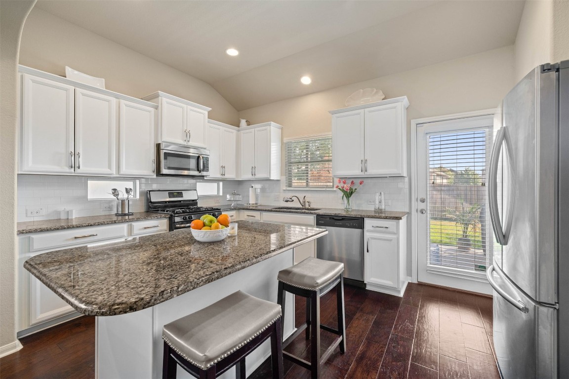2424 Republic Trail Leander, TX 78641 - Photo 1 of 1 a kitchen with stainless steel appliances granite countertop a refrigerator sink stove microwave and cabinets