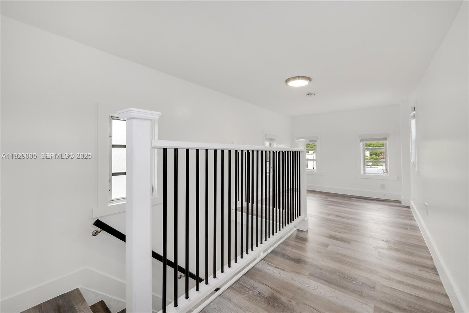 1736 Southwest 9th Street, Unit 1738 Miami, FL 33135 - Photo 11 of 15 a view of a hallway with wooden floor and stairs