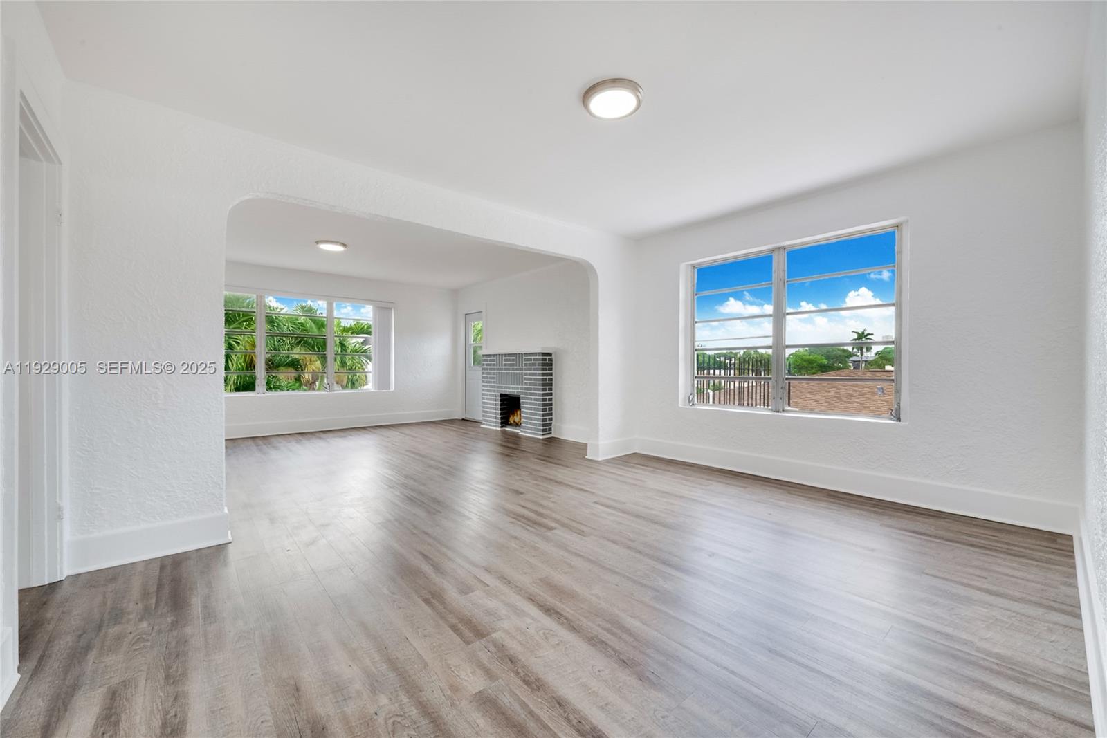 1736 Southwest 9th Street, Unit 1738 Miami, FL 33135 - Photo 5 of 15 an empty room with wooden floor and windows