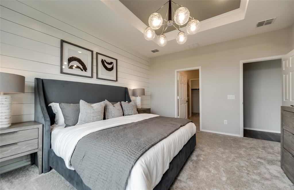 7509 Bent Gale Road Pilot Point, TX 76258 - Photo 11 of 26 a bedroom with a large bed and a chandelier