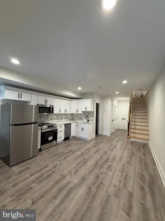 a kitchen with stainless steel appliances a refrigerator and a stove top oven