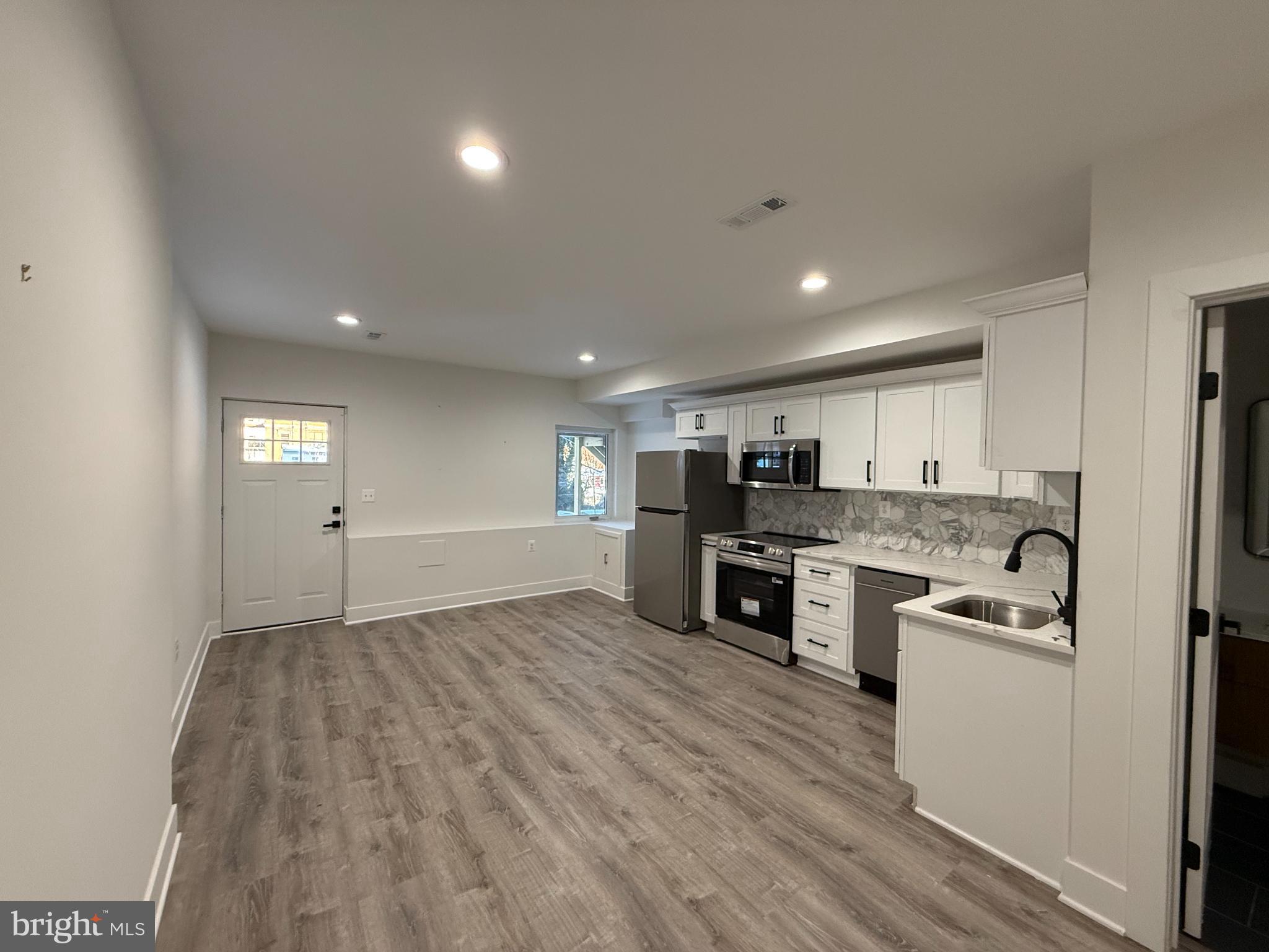 3923 Roland Avenue Baltimore, MD 21211 - Photo 2 of 13 a view of kitchen with sink microwave and stove