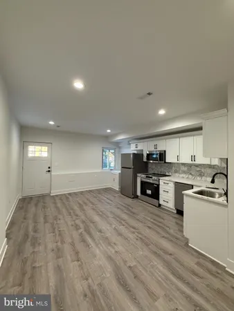 a view of a kitchen with a sink and a refrigerator