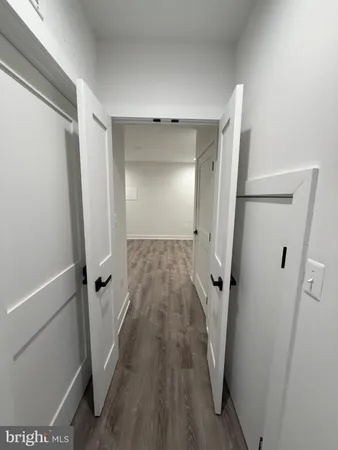a view of a room with wooden floor and a ceiling fan