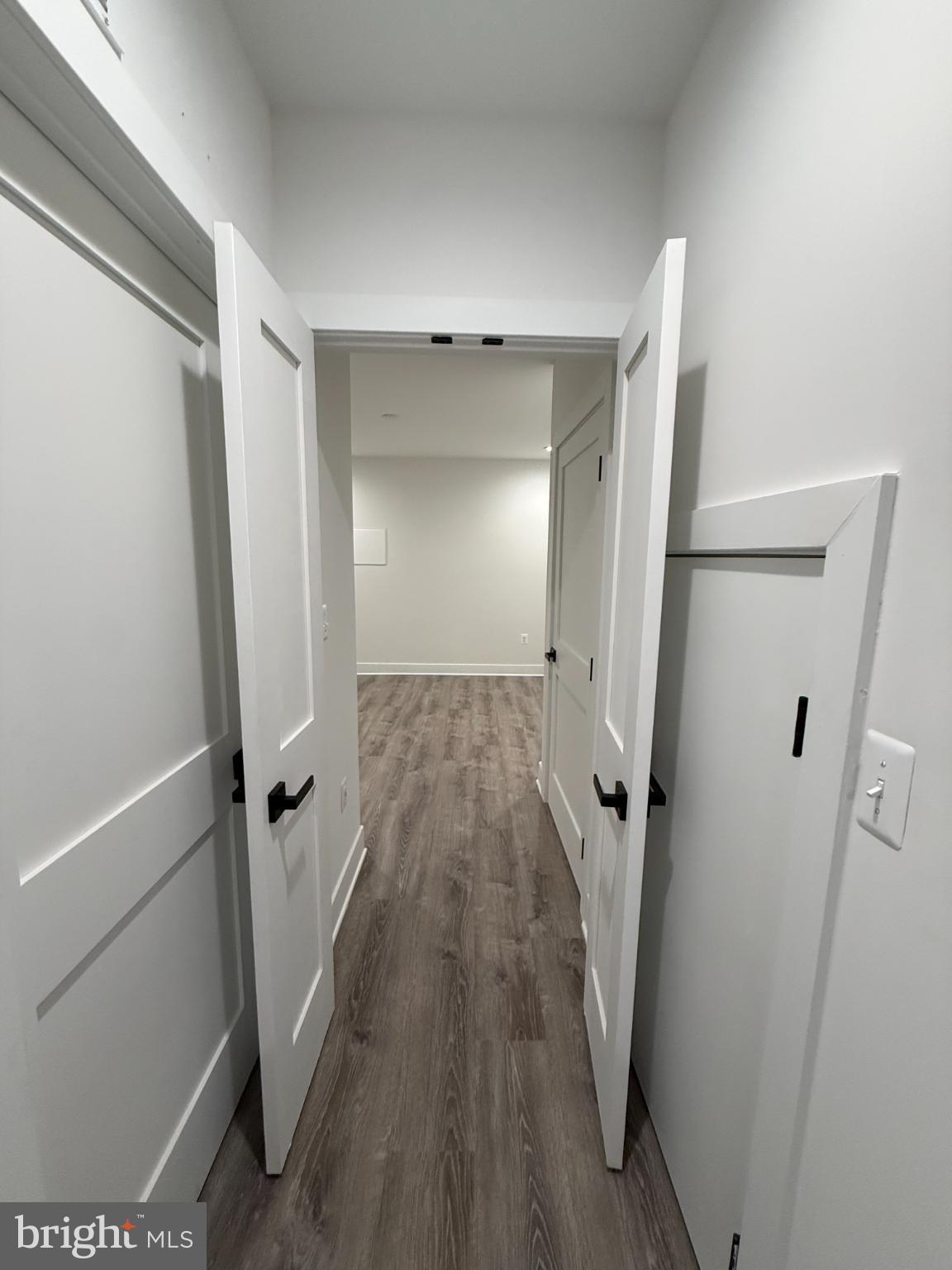 3923 Roland Avenue Baltimore, MD 21211 - Photo 9 of 13 a view of a room with wooden floor and a ceiling fan