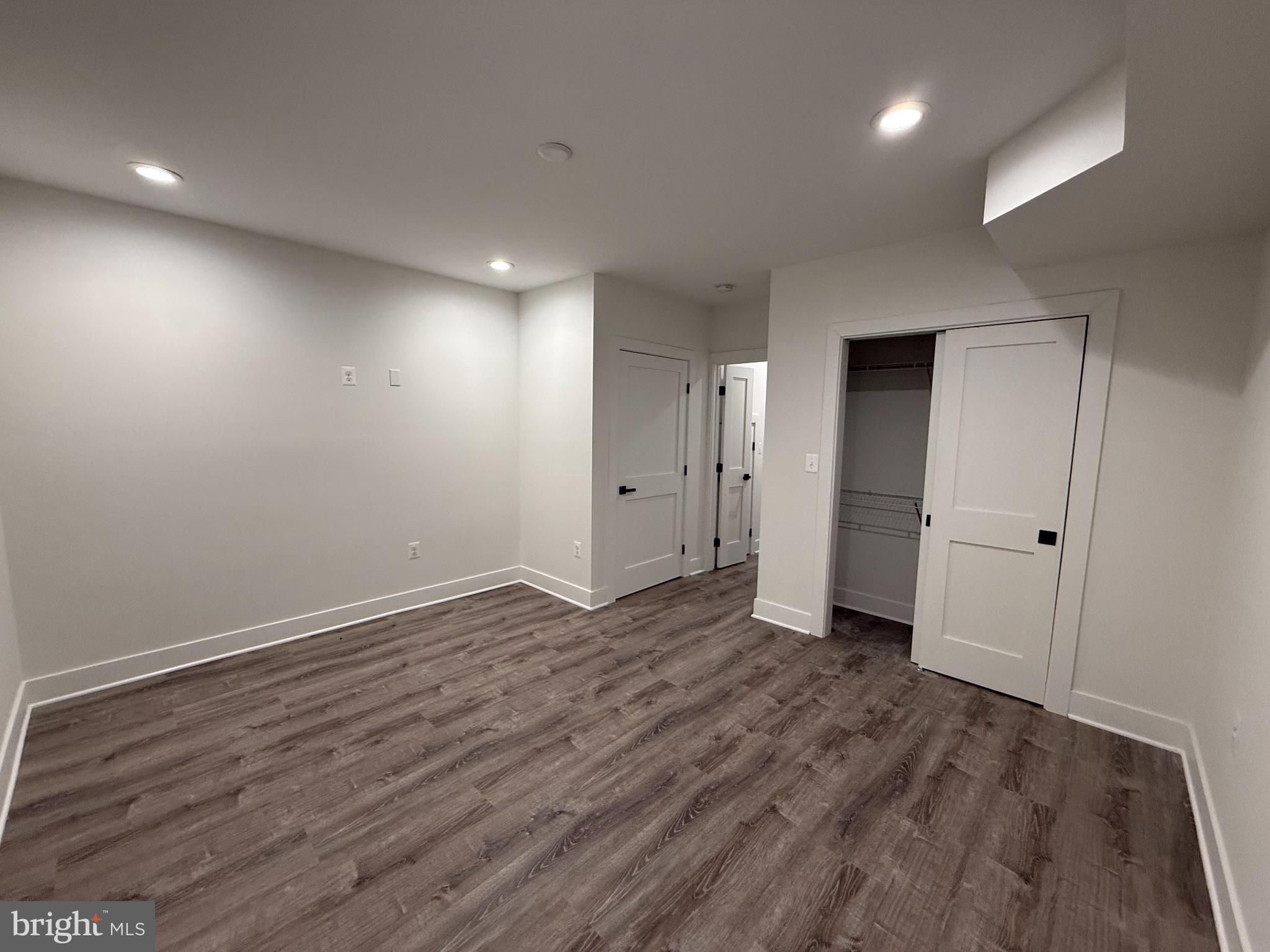 3923 Roland Avenue Baltimore, MD 21211 - Photo 10 of 13 a view of an empty room with wooden floor