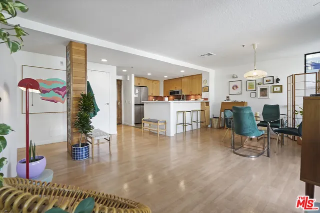 a living room with furniture and kitchen view