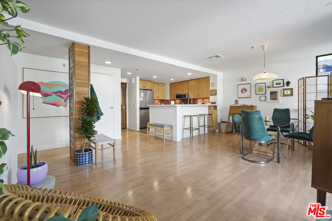 a living room with furniture and kitchen view