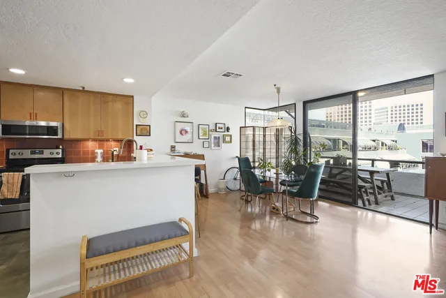 a living room with stainless steel appliances kitchen island granite countertop furniture and a kitchen view