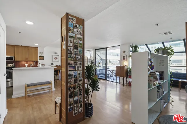a workspace with furniture and floor to ceiling window