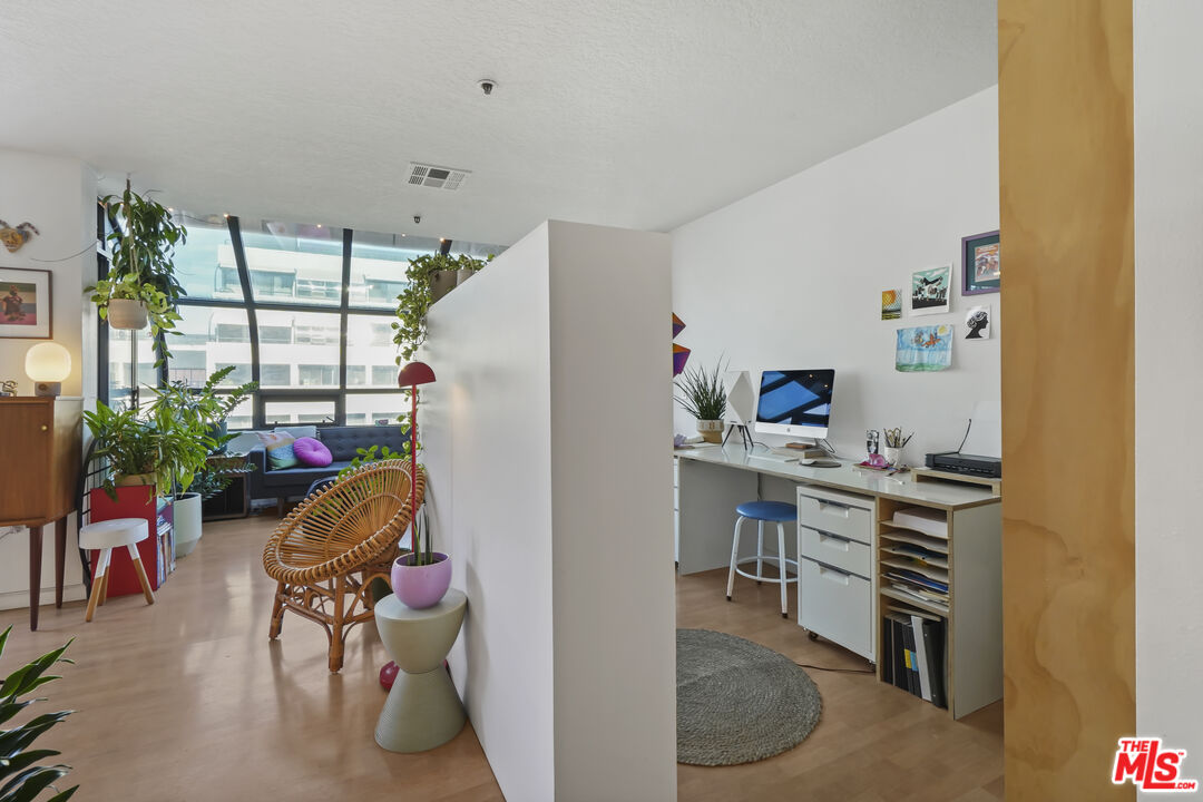 880 West 1st Street, Unit 604 Los Angeles, CA 90012 - Photo 20 of 60 a living room with furniture and a window
