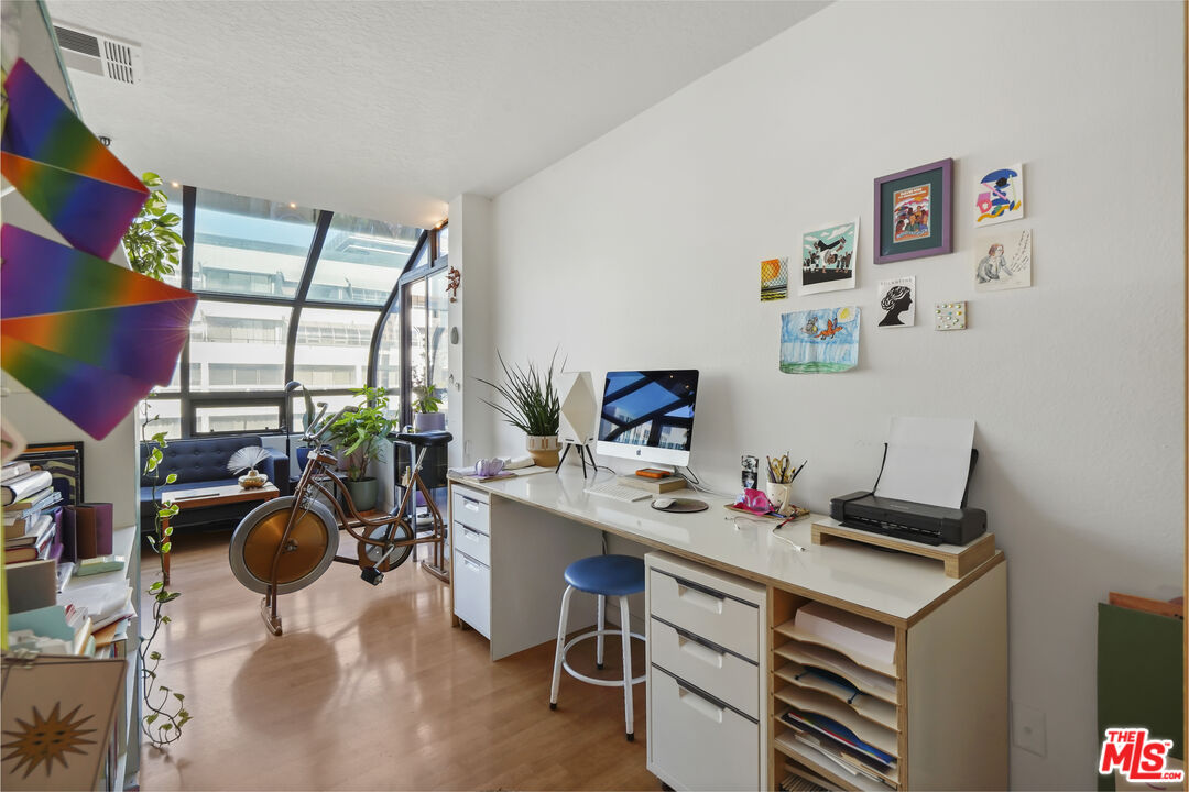 880 West 1st Street, Unit 604 Los Angeles, CA 90012 - Photo 21 of 60 a workspace with furniture and floor to ceiling window