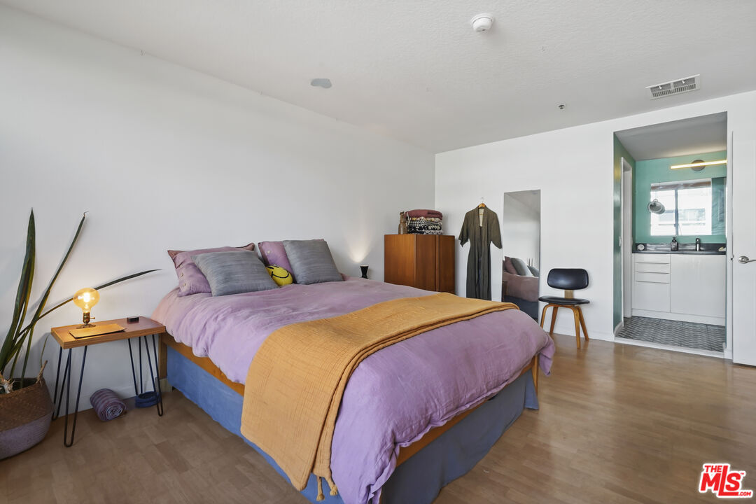 880 West 1st Street, Unit 604 Los Angeles, CA 90012 - Photo 24 of 60 a bedroom with bed and a table