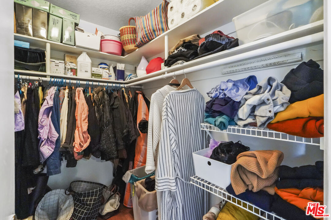 880 West 1st Street, Unit 604 Los Angeles, CA 90012 - Photo 27 of 60 a view of walk in closet with clothes and shoes