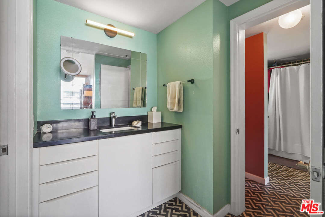 880 West 1st Street, Unit 604 Los Angeles, CA 90012 - Photo 31 of 60 a bathroom with a double vanity sink and mirror