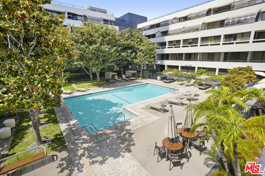 880 West 1st Street, Unit 604 Los Angeles, CA 90012 - Photo 36 of 60 a view of a swimming pool with a lawn chairs and potted plants
