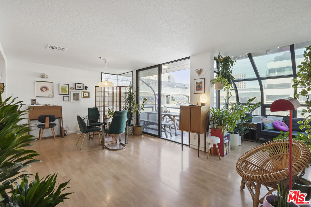 880 West 1st Street, Unit 604 Los Angeles, CA 90012 - Photo 4 of 60 a living room with furniture large window and wooden floor