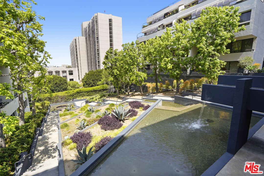 880 West 1st Street, Unit 604 Los Angeles, CA 90012 - Photo 43 of 60 a view of a swimming pool with a lawn chairs and plants