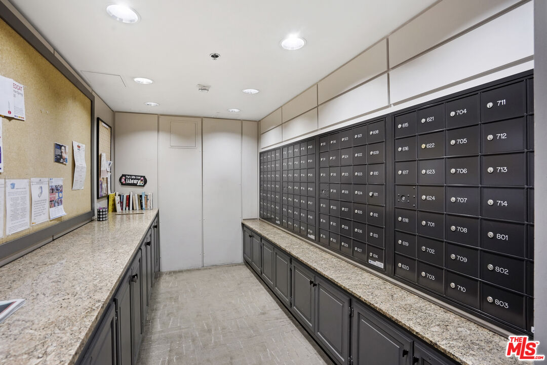 880 West 1st Street, Unit 604 Los Angeles, CA 90012 - Photo 56 of 60 a kitchen with stainless steel appliances granite countertop a sink and stove