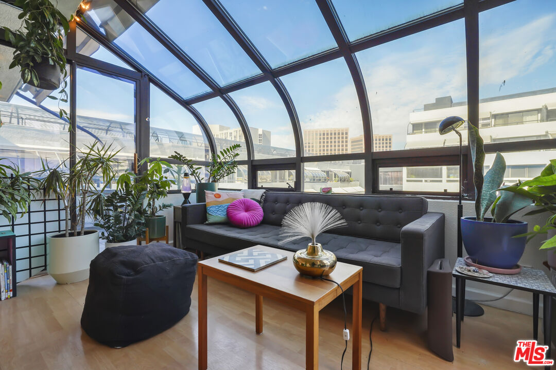 880 West 1st Street, Unit 604 Los Angeles, CA 90012 - Photo 7 of 60 a living room with furniture and a floor to ceiling window
