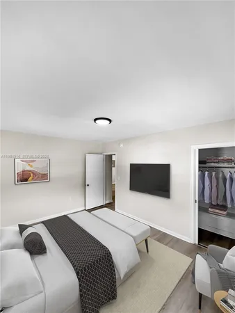a bedroom with a bed and a flat screen tv