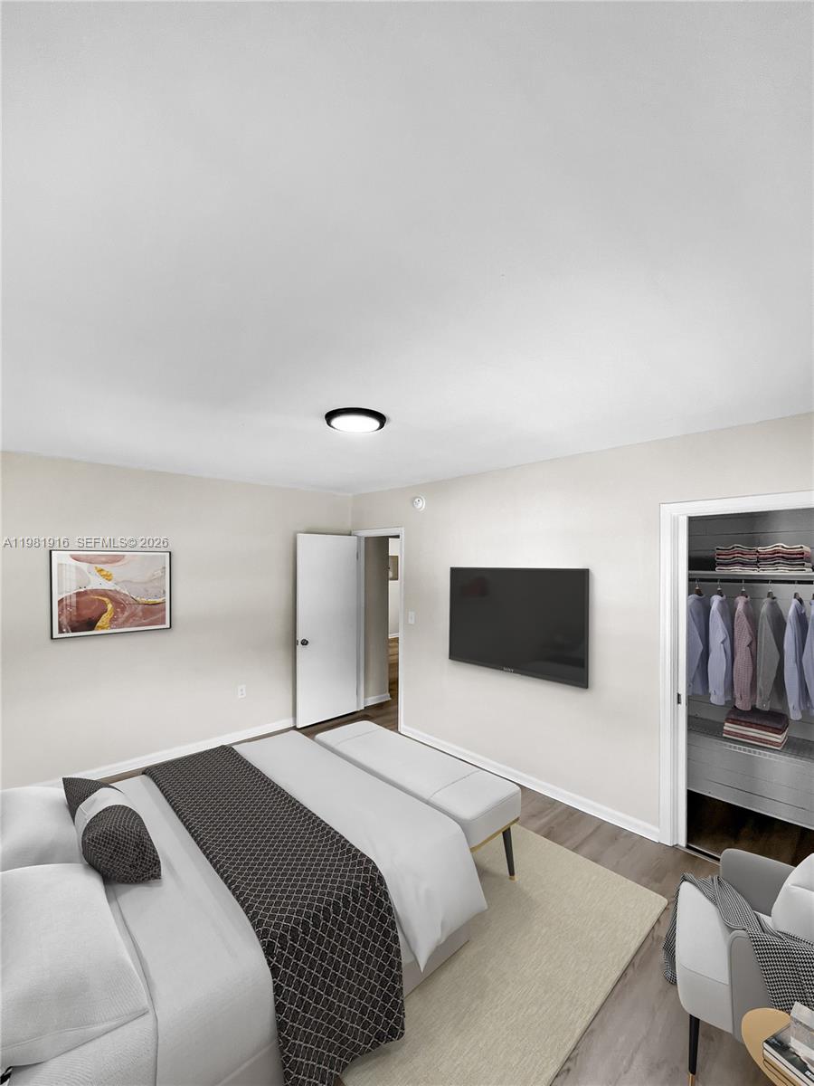 2390 Southwest 22nd Street, Unit 4 Miami, FL 33145 - Photo 8 of 10 a bedroom with a bed and a flat screen tv