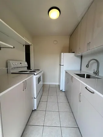 a kitchen that has a sink and a stove