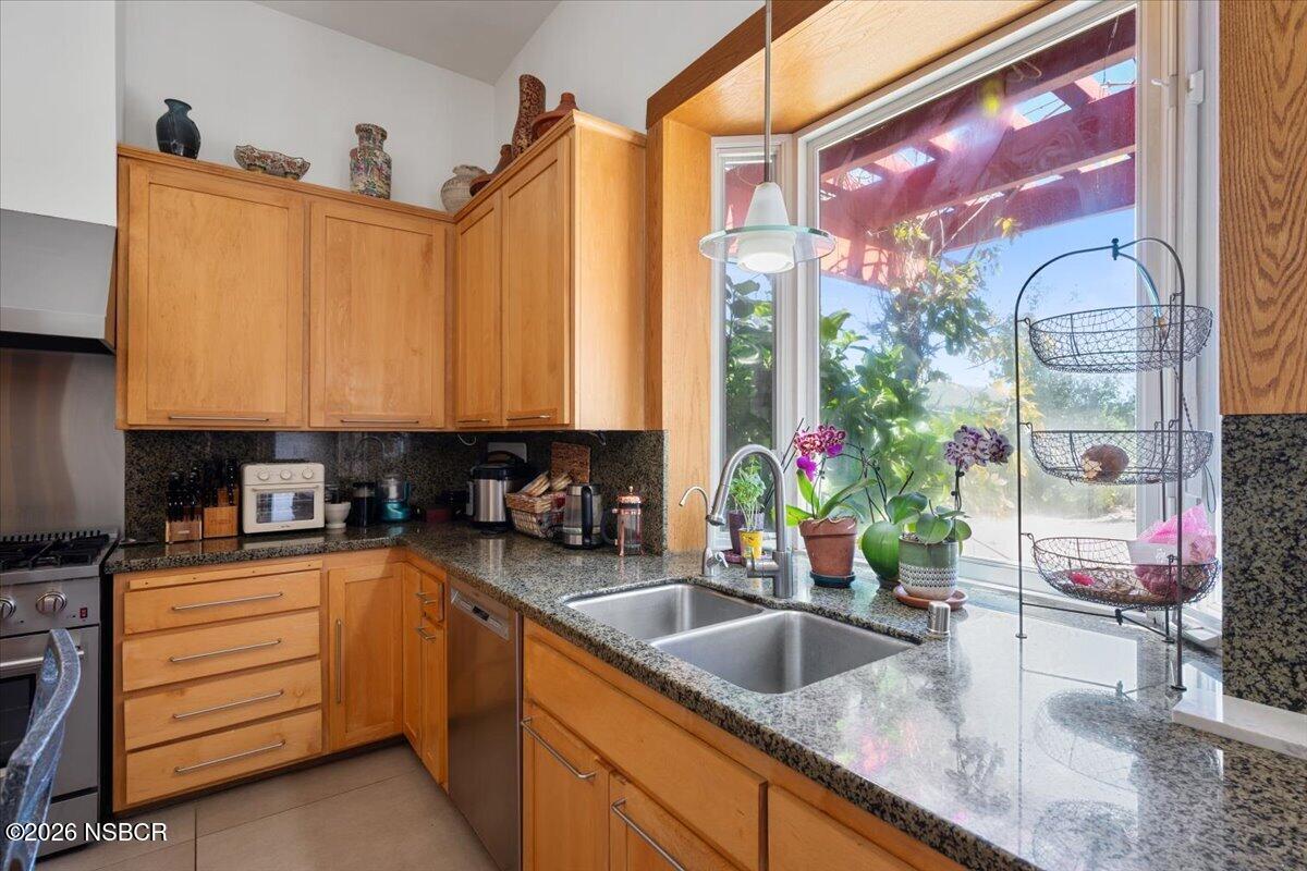 1012 Upper Los Berros Road Nipomo, CA 93444 - Photo 12 of 67 a kitchen with stainless steel appliances kitchen island granite countertop a sink and a granite counter tops