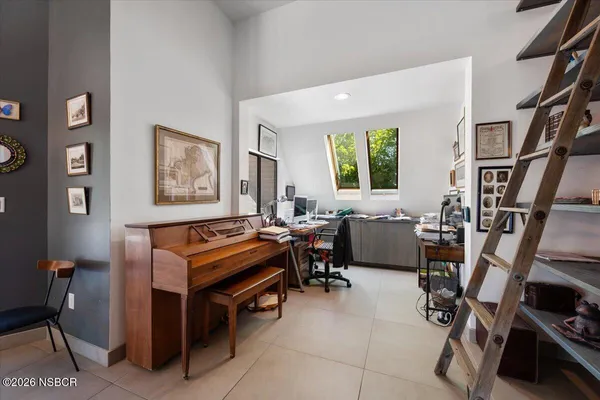 a bedroom with a bed and a flat tv screen
