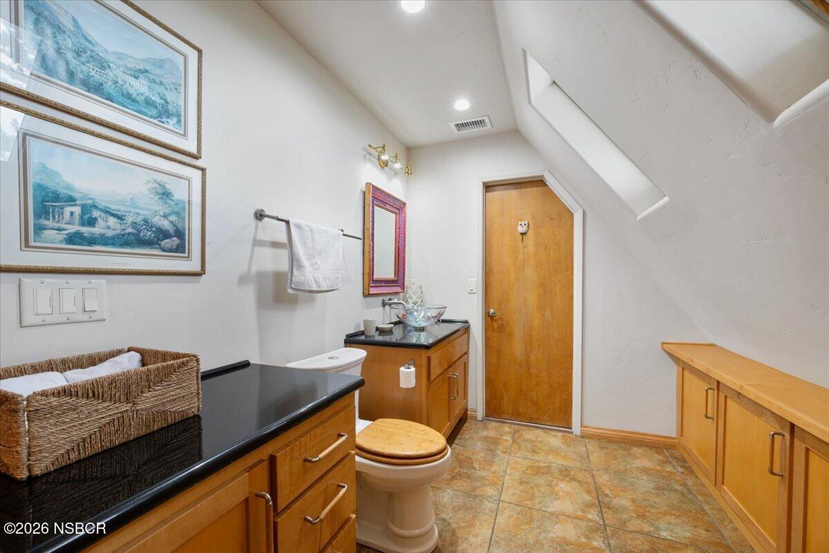 1012 Upper Los Berros Road Nipomo, CA 93444 - Photo 26 of 67 a bathroom with a granite countertop sink and a mirror
