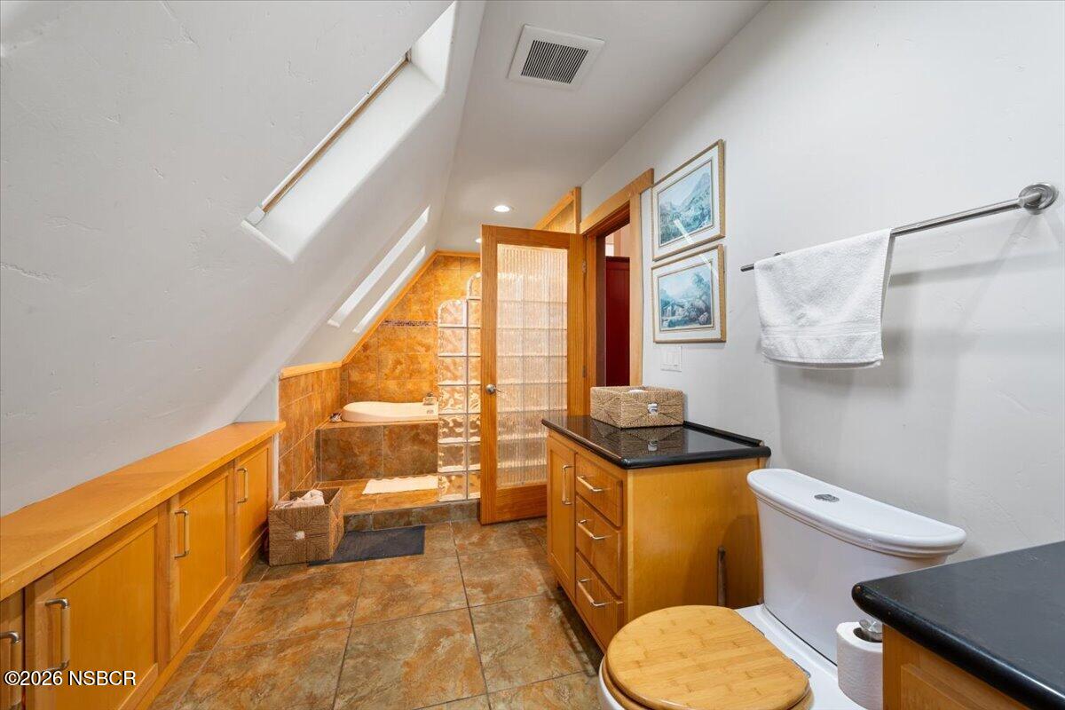 1012 Upper Los Berros Road Nipomo, CA 93444 - Photo 27 of 67 a bathroom with a granite countertop toilet a sink and a mirror